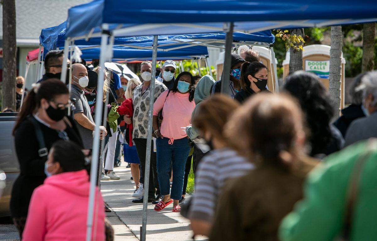People wait to get vaccinated for Covid-19 Thursday in front of the Allen Park Community Center, 1770 NE 162nd St., North Miami Beach . Two new satellite federal vaccination sites opened on Thursday. One in North Miami Beach and the other in Miami Springs