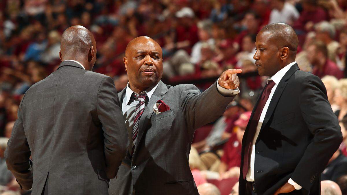 Standing between Florida State assistant coaches Charlton Young and Dennis Gates, head coach Leonard Hamilton points in the second half of an NCAA college basketball game against Winthrop in Tallahassee, Fla., Tuesday, Jan. 1, 2019. Florida State won 87-76.