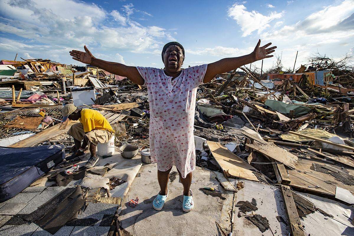 Aliana Alexis of Haiti stands on the concrete slab of what is left of her home after destruction from Hurricane Dorian in an area called “The Mudd” at Marsh Harbour in Great Abaco Island, Bahamas, on Thursday, Sept. 5, 2019.