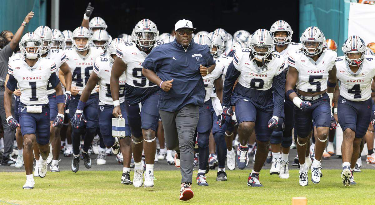 Howard Bison head coach Larry Scott runs on the field with his players before playing against Florida A&M Rattlers in their Orange Blossom Classic football game at Hard Rock Stadium on Saturday, Aug. 30, 2025, in Miami Gardens, Fla.