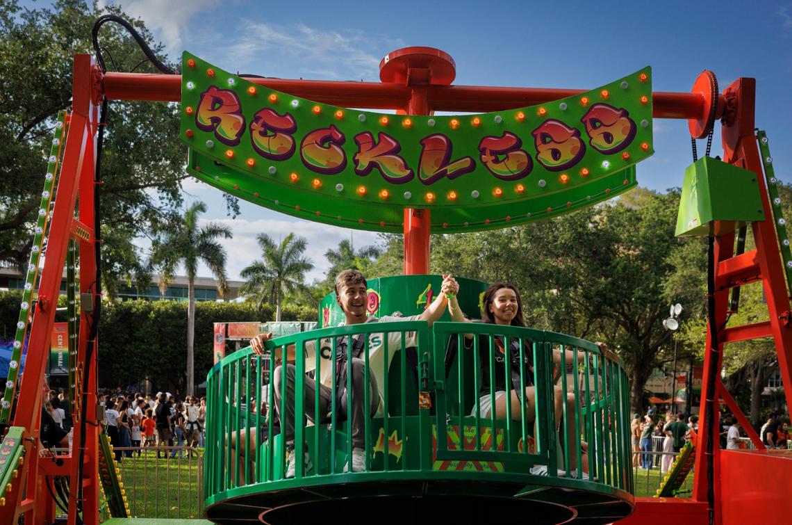 Kevin Malave, left, and Catherine Bizet hold hands while riding the Reckless ride during the University of Miami Centennial celebration on Tuesday, April 8, 2025, on Foote University Green at the University of Miami’s Coral Gables campus. “We came out to show some school spirit and enjoy the atmosphere,” said Malave.