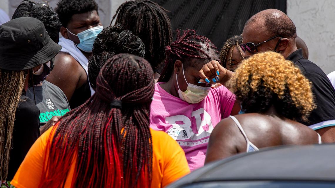 Shanlavie Drayton, the mother of the slain 7-year-old girl Alana Washington and grandmother to the 16-month-old boy who was wounded in a drive-by shooting Saturday night, grieves while surrounded by her family before a public plea to the community for any information that might lead to the arrest of the shooters in Brownsville, Florida on Monday, July 27, 2020.