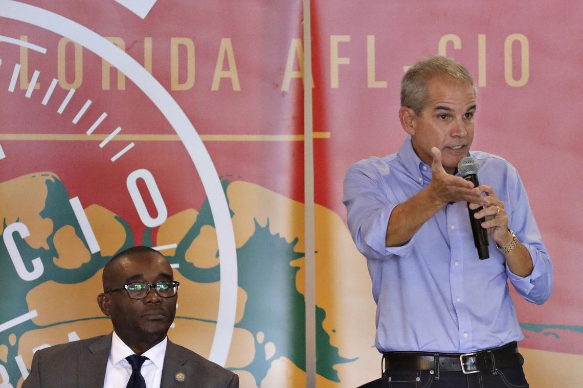 Mayoral candidate Alex Penelas, right, responds to a question as Jean Monestime listens during the Miami-Dade County Mayoral Candidate Forum held in Doral, Florida on October 21, 2019. The transportation tax passed while Penelas was mayor in 2002 is the subject of a critical memo issued by one of his successors, incumbent Mayor Carlos Gimenez.