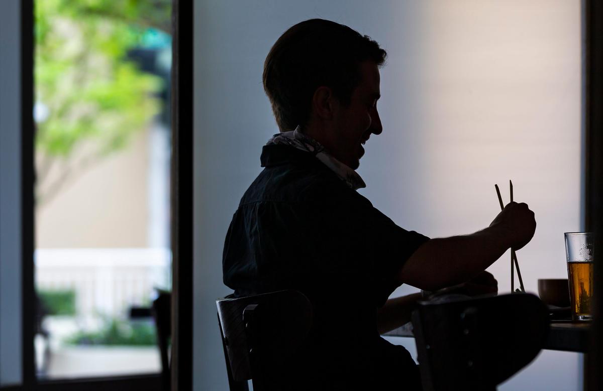 Herbert Eckardt, 26, eats lunch with his coworkers at Pubbelly Sushi in Dadeland on the first day Miami-Dade County allowed restaurants to reopen their dining rooms on Monday, May 18, 2020. In order to control the spread of the coronavirus, Miami officials prohibited restaurants from operating their dining rooms on March 16, 2020.