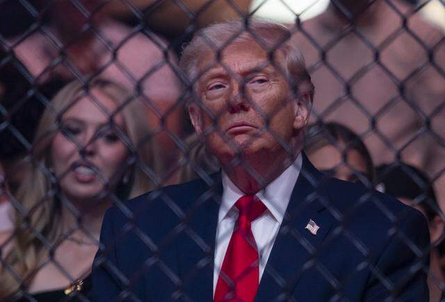 President Donald Trump looks on after Cub Swanson of the United States and Nate Landwehr of the United States fought in their featherweight bout at UFC 327 at the Kaseya Center on Saturday, April 11, 2026, in downtown Miami, Fla.