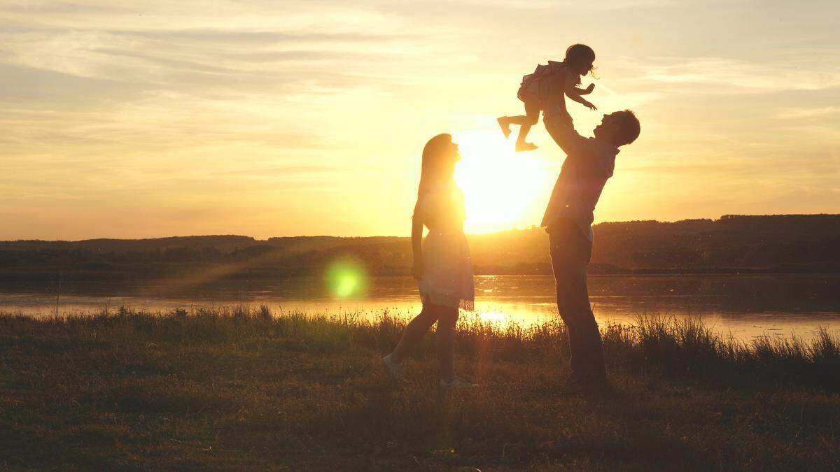 family enjoy special moment with sunset