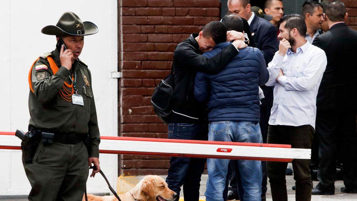 Relatives of members of the Colombia Police Department arrive near the scene where a car bomb exploded on Jan. 17, 2019, in Bogotá, Colombia. The National Liberation Army, known as ELN, has claimed responsibility for the bombing.