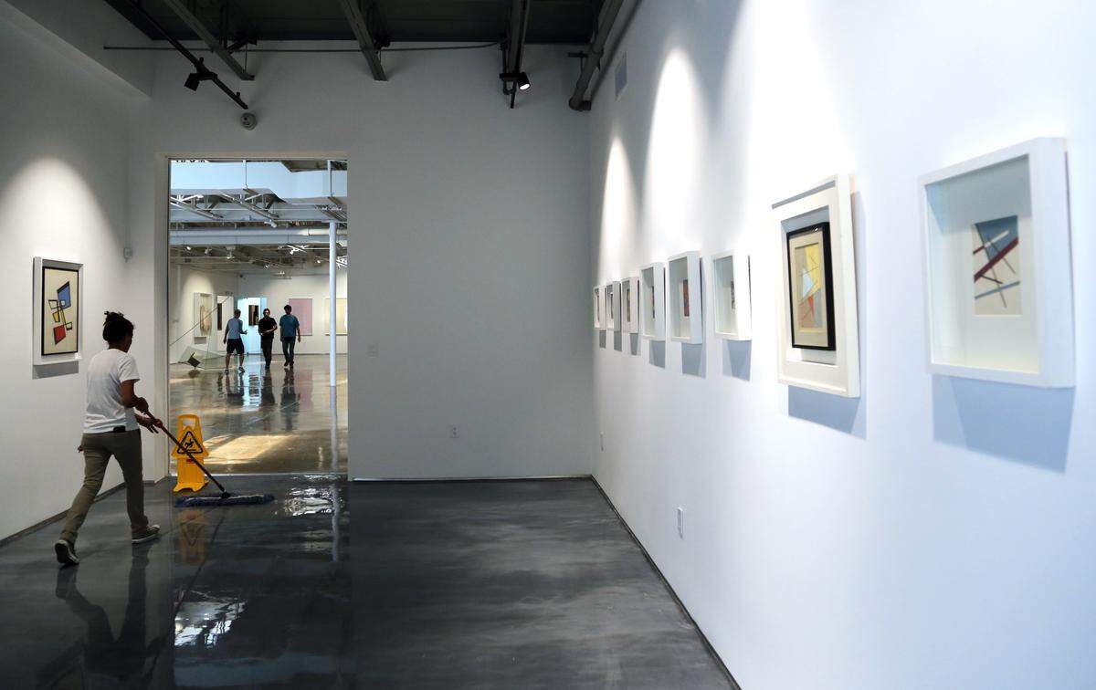 Olga Filpo, operator of industrial and office cleaning company, preps the space for the opening of Atchugarry Art Center in Little Haiti. Sculptor and gallerist Pablo Atchugarry along with his son, Piero, has opened the gallery featuring some of his sculptures.