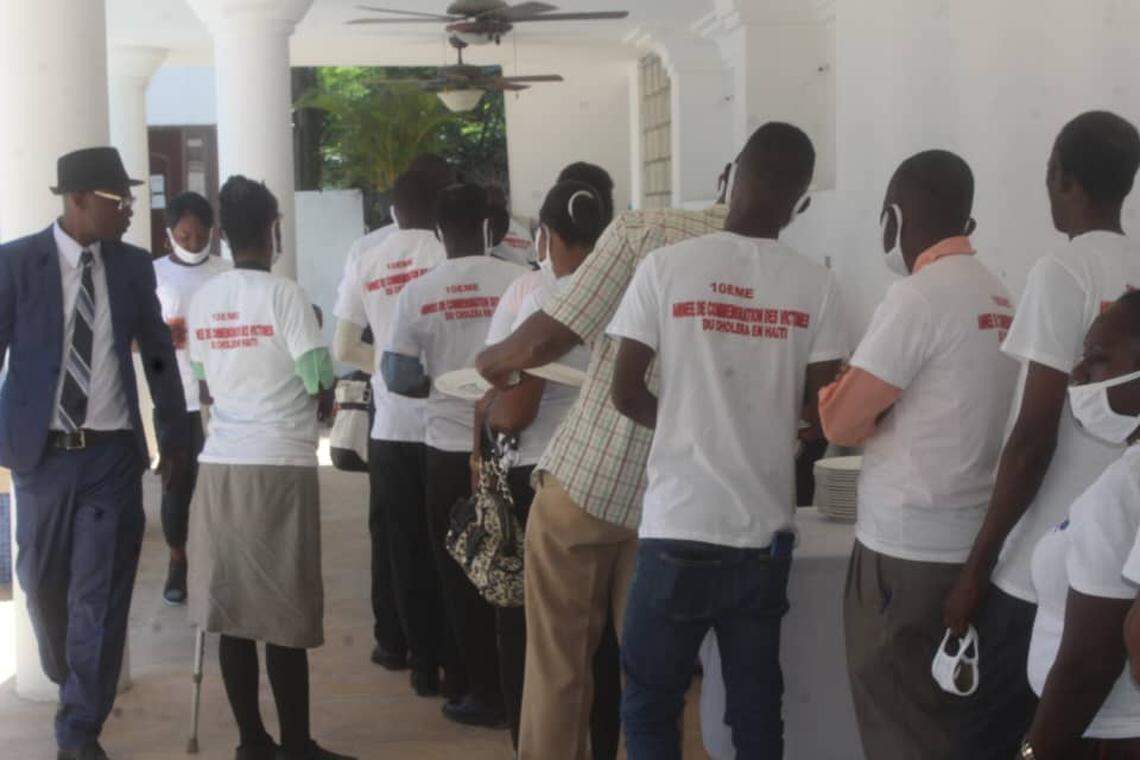 Berthony Clermont, 46, in blue, commemorates the 10th anniversary of the arrival of cholera in Haiti with other Haitians and victims of the disease at a Port-au-Prince hotel on Wednesday, October 21, 2010, in “A Day of Reflection.” Clermont, who contracted the disease in 2014, is an advocate on behalf of those demanding compensation from the United Nations.