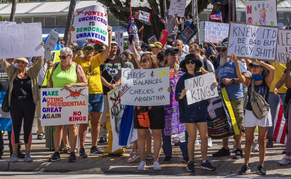 Protesters with signs at the Miami Torch of Friendship in downtown Miami during the ‘No Kings’ anti-Trump protests on Oct. 18, 2025.