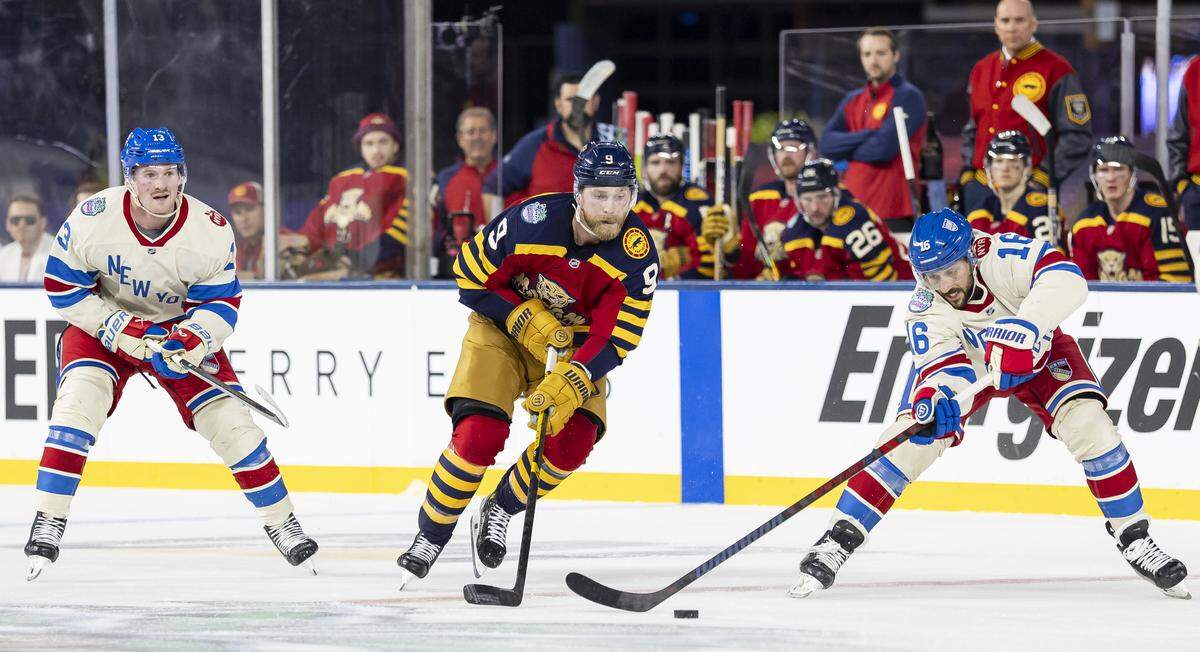 Florida Panthers center Sam Bennett (9) skates with the puck as New York Rangers center Vincent Trocheck (16) defends in the third period of their Winter Classic outdoor hockey game at loanDepot park on Friday, Jan. 2, 2026, in Miami, Fla.