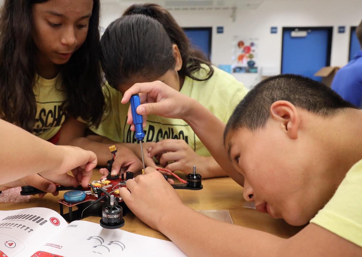 Elsie Garcia, left, and Amanda Rivas, center, assist Ting Has Hu in building a drone. Florida Power & Light Company (FPL) partnered with After-School All-Stars South Florida to support the Discover Drones program, teaching low-income, at-risk middle school students a world of innovation and technology through drones on Wednesday, July 24, 2019, at Ruben Dario Middle School in Miami, Florida.