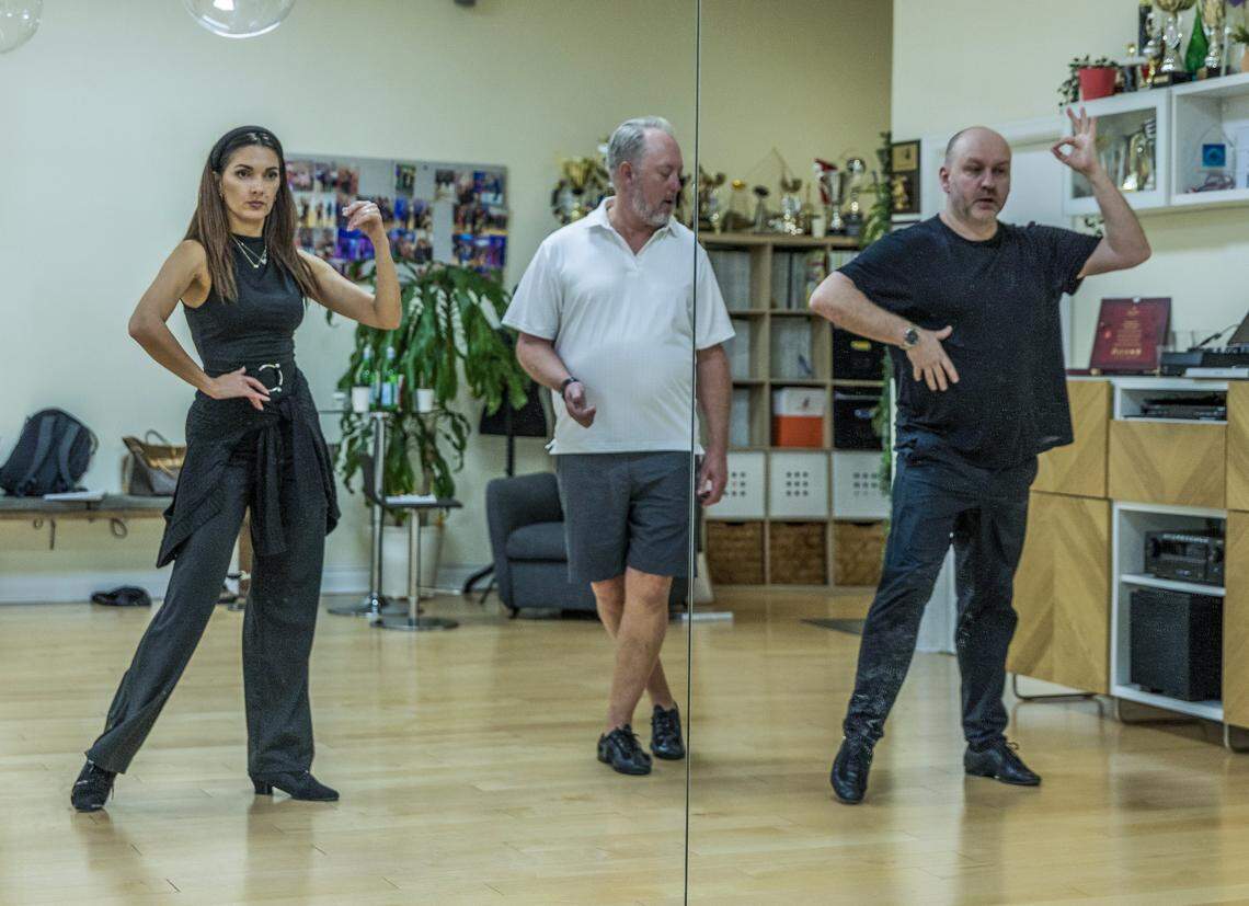 Dance instructors Daniela Vacaru and Markus Homm, demonstrate to student Patrick Shelton (center) during a class at Let's Dance Miami studio in Aventura, on Wednesday, February 18, 2026.