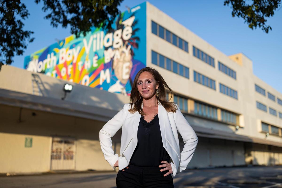 North Bay Village Commissioner Rachel Streitfeld stands in front of a building approved for redevelopment. Sunbeam Properties plans to convert the site to a 65-story residential tower and more as part of a 13-acre project.