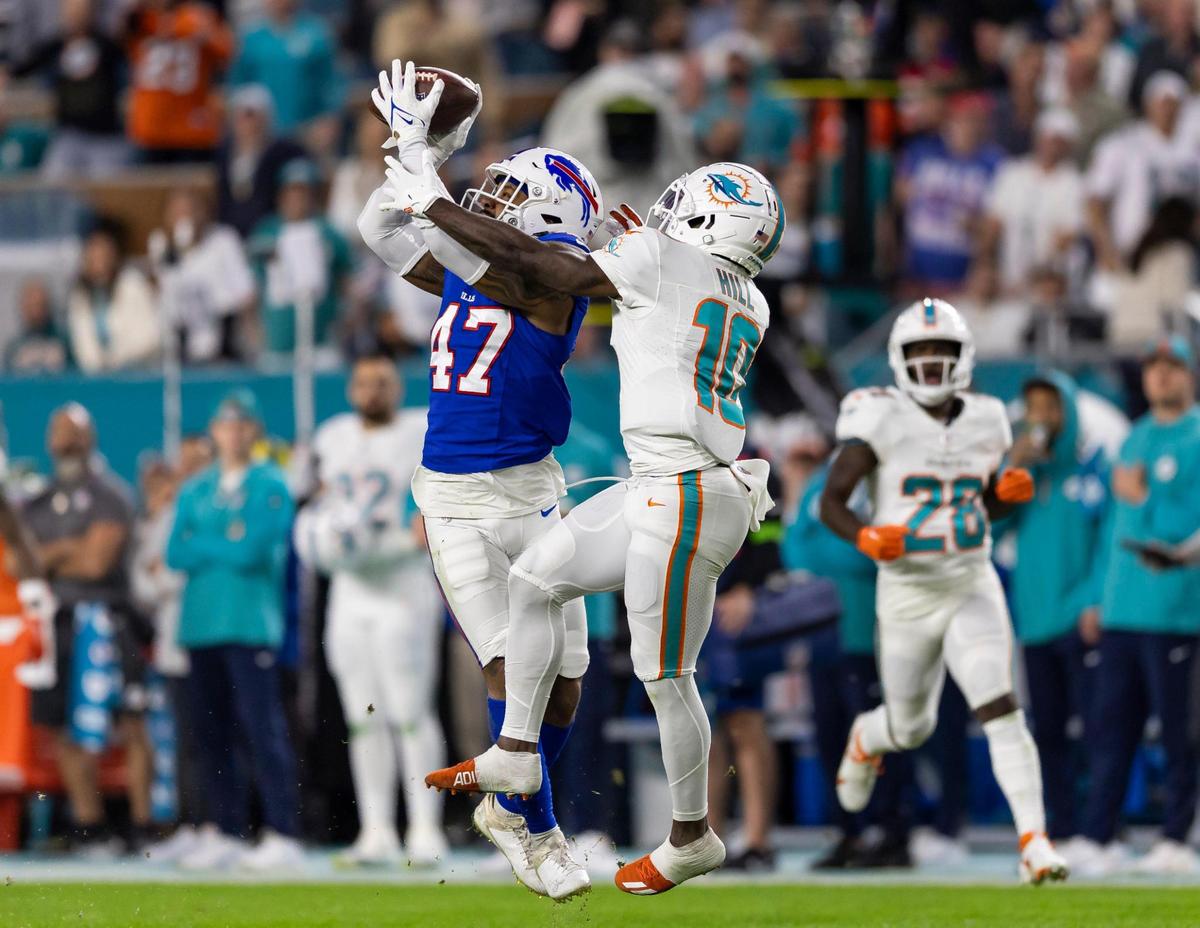 Buffalo Bills cornerback Christian Benford (47) intercepts a pass to Miami Dolphins wide receiver Tyreek Hill (10) in the first quarter of an NFL game at Hard Rock Stadium on Sunday, Jan. 7, 2023, in Miami Gardens Fla.