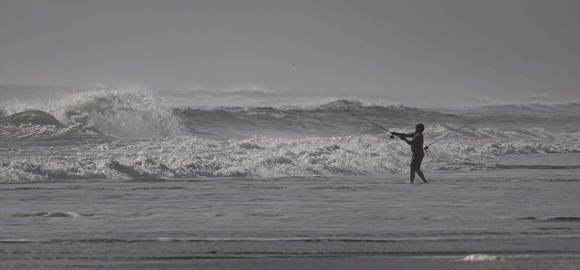 A man is seen fishing near Canova Beach Park on Thursday, Oct. 16, 2025, in Indian Harbour Beach, Fla.