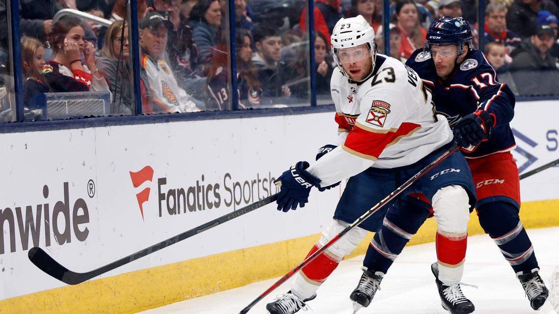 Florida Panthers forward Carter Verhaeghe, left, chases the puck in front of Columbus Blue Jackets forward Justin Danforth during the first period of an NHL hockey game in Columbus, Ohio, Sunday, Dec. 10, 2023. (AP Photo/Paul Vernon)