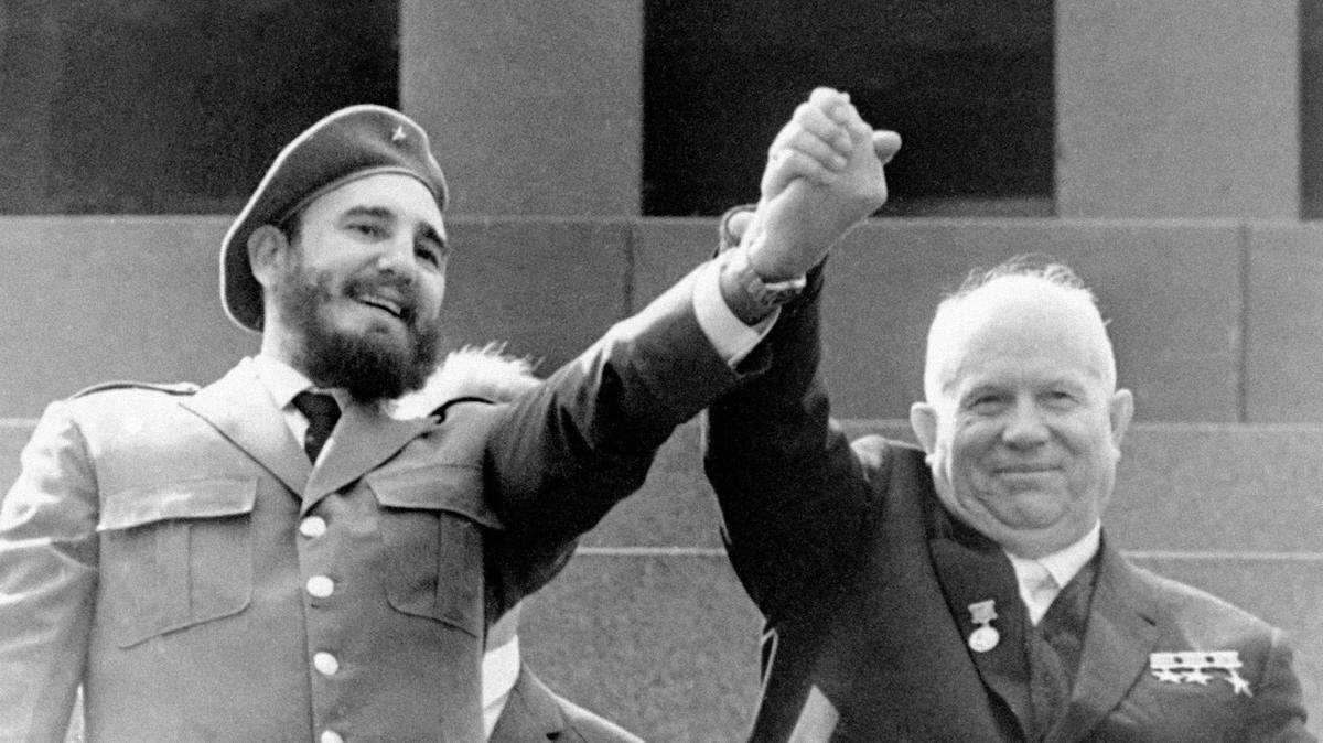In this May 1, 1963, file photo, Cuba’s leader Fidel Castro, left, and Soviet Premier Nikita Khrushchev clasp hands at the Lenin mausoleum in Moscow’s Red Square on May Day in Moscow, Russia. TASS via AP, File