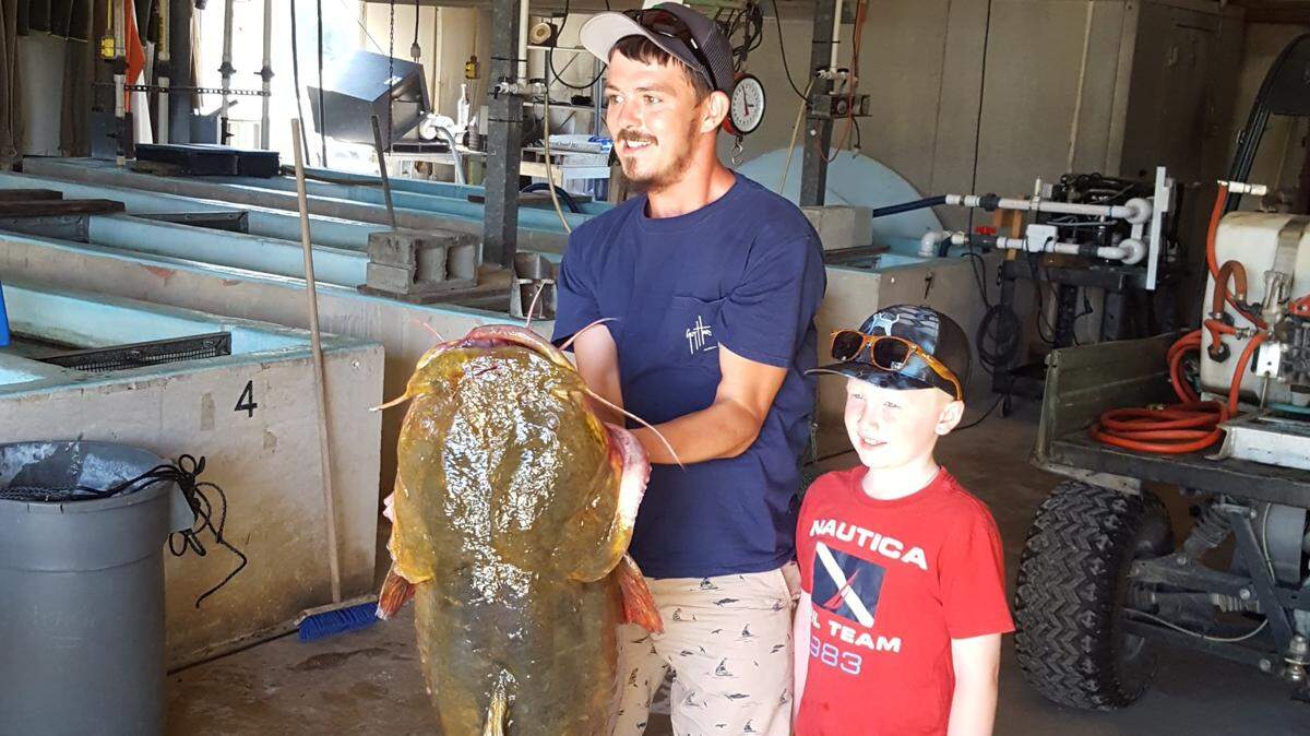 Marvin Griffin poses with his flathead catfish, which broke the state record, weighing 69.3 pounds and measuring 47 inches long with a girth of 34.25 inches, according to the Florida Fish and Wildlife Conservation Commission.