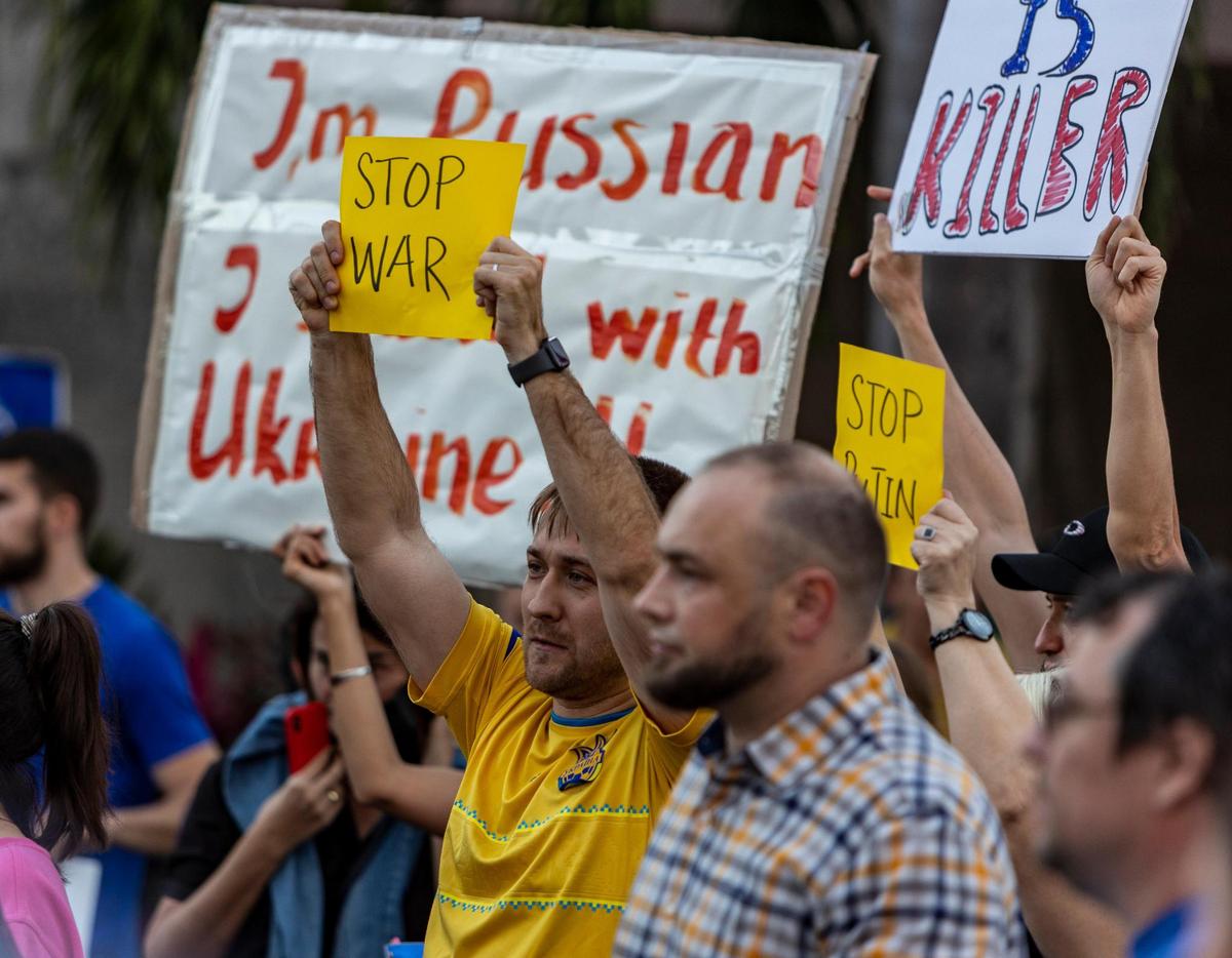 Hallandale Beach, Florida, February 24, 2022 - Man holds a small No War sign during the demonstration. Members of the Ukrainian and Russian communities in South Florida gathered in front of Hallandale Beach City Hall in support of the Ukraine after Russian forces invaded the country earlier in the day.