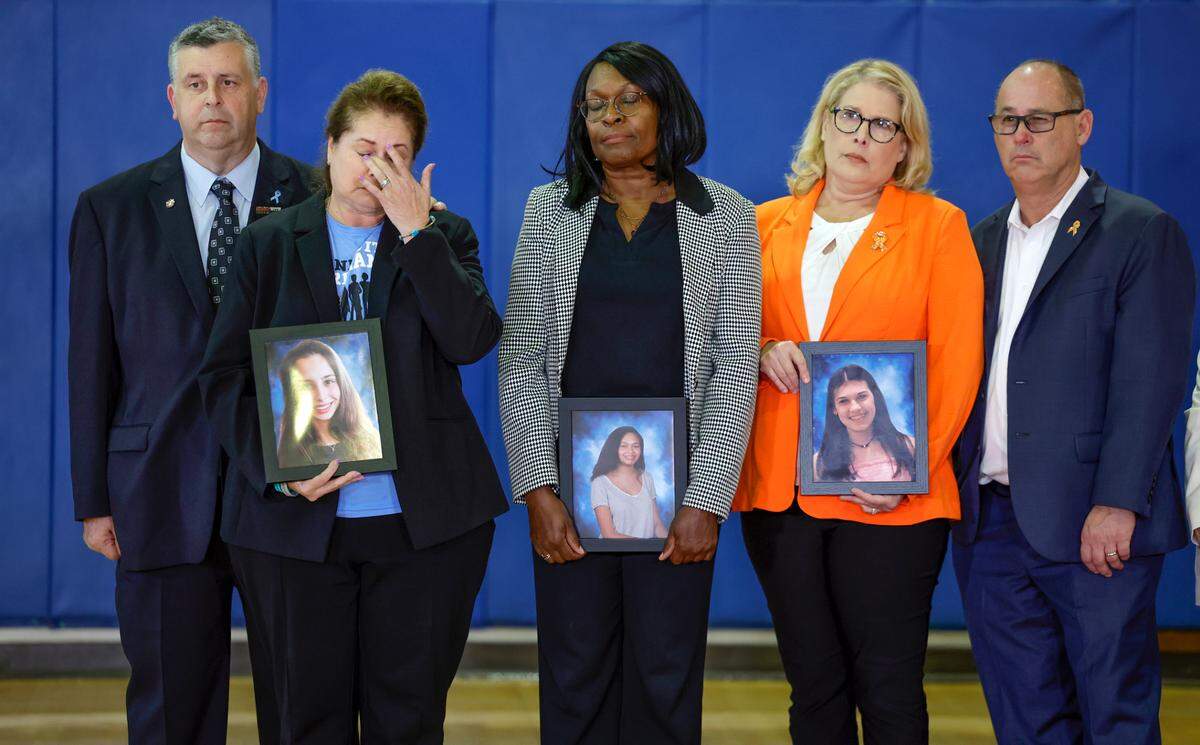 The families of students who were killed during the shooting at Marjory Stoneman Douglas High School six years ago react as Vice President Kamala Harris speaks during a visit to the school in Parkland on Saturday, March 23, 2024. From left are Tony and Jennifer Montalto, parents of Gina; Anne Ramsay, mother of Helena; and Fred and Jennifer Guttenberg, parents of Jaime.