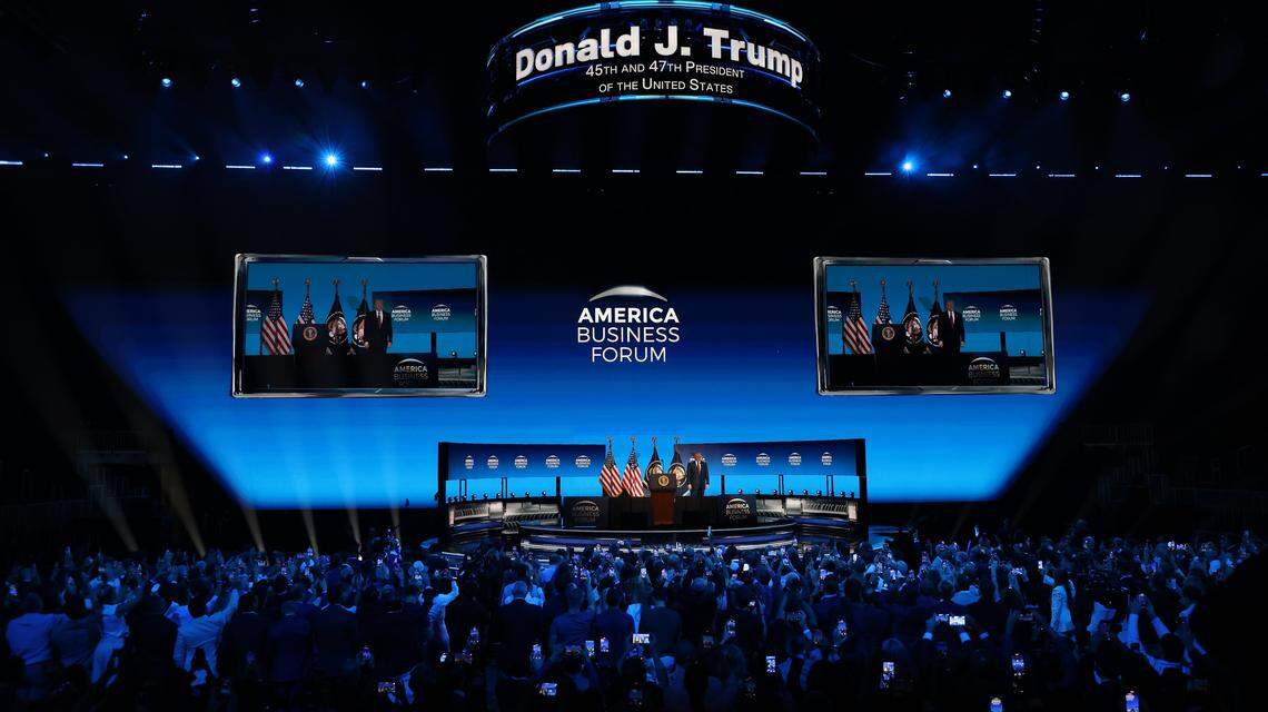 President Donald J. Trump walks on stage as VIP attendees pull out their cellphone during the American Business Forum at the Kaseya Center in Miami, Florida on Wednesday, November 5, 2025.