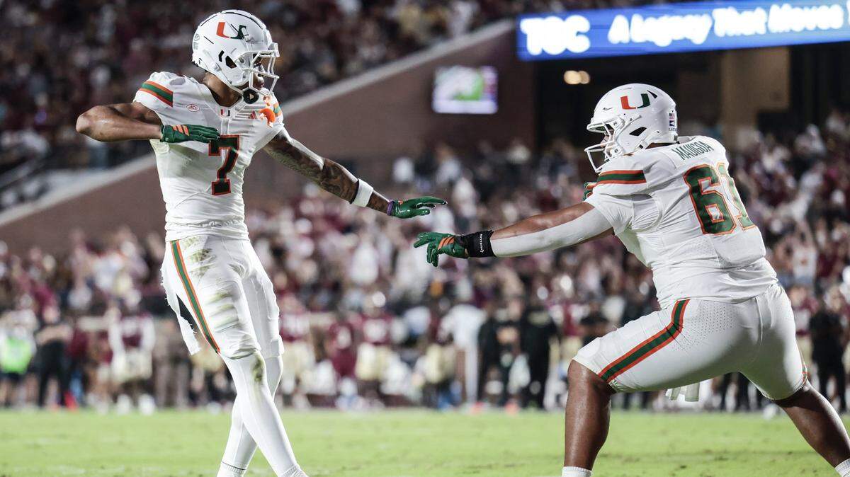 Miami Hurricanes wide receiver CJ Daniels (7) and offensive lineman Francis Mauigoa (61) celebrate after Daniels scores in the first half of the NCAA game against the Florida State Seminoles at Doak Campbell Stadium in Tallahassee, Florida, on Saturday, October 4, 2025.