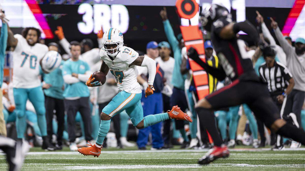 Miami Dolphins wide receiver Jaylen Waddle (17) runs with the ball to score a touchdown against the Atlanta Falcons in the second half of their NFL game at Mercedes-Benz Stadium on Sunday, Oct. 26, 2025, in Atlanta, Ga.