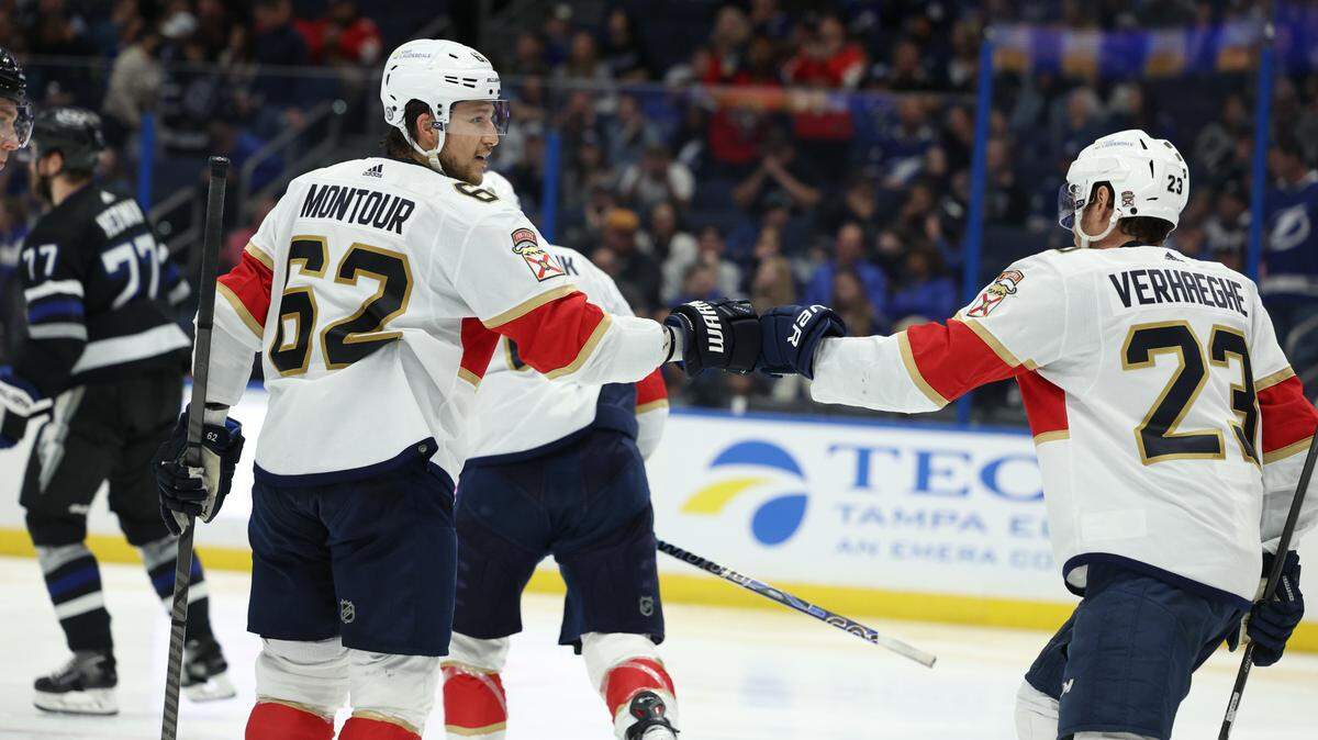 Feb 17, 2024; Tampa, Florida, USA; Florida Panthers defenseman Brandon Montour (62) and center Carter Verhaeghe (23) celebrate a goal against the Tampa Bay Lightning in the second period at Amalie Arena.