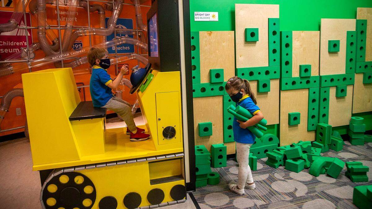 Mason Dudash, left, and Paula Gonzalez play at the Miami Children’s Museum, which is reopening gradually, on April 27. “Keeping your kids’ minds sharp in the summer should not come at the cost of them not enjoying themselves, and it doesn’t have to,” says Kathleen Dexter, a program manager for The Children’s Trust.
