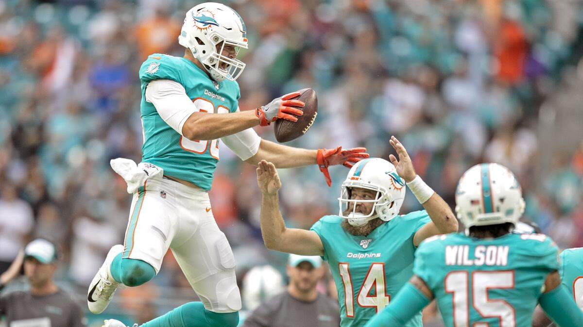 Miami Dolphins tight end Mike Gesicki (88) and quarterback Ryan Fitzpatrick (14) celebrate Gesicki’s second quarter touchdown as the Miami Dolphins beat the Cincinnati Bengals at Hard Rock Stadium in Miami Gardens on Sunday, December 22, 2019.