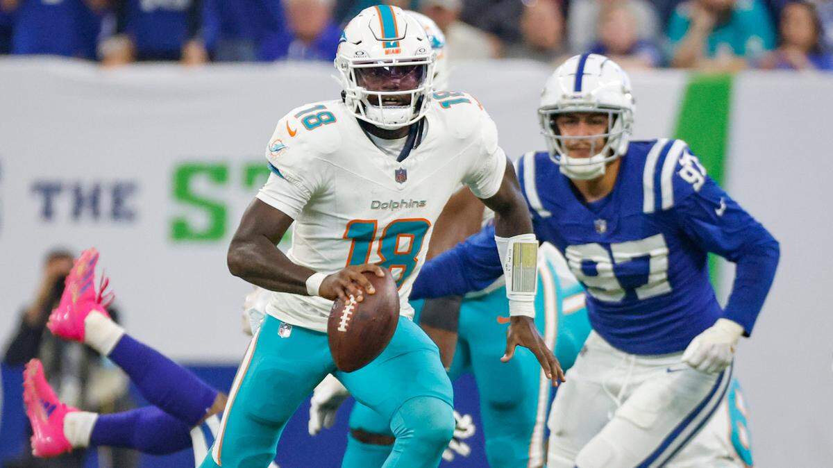 Miami Dolphins quarterback Tyler Huntley (18) scrambles with the ball against the Indianapolis Colts in the first half during an NFL football game in Indianapolis, Indiana on Sunday, October 20, 2024.