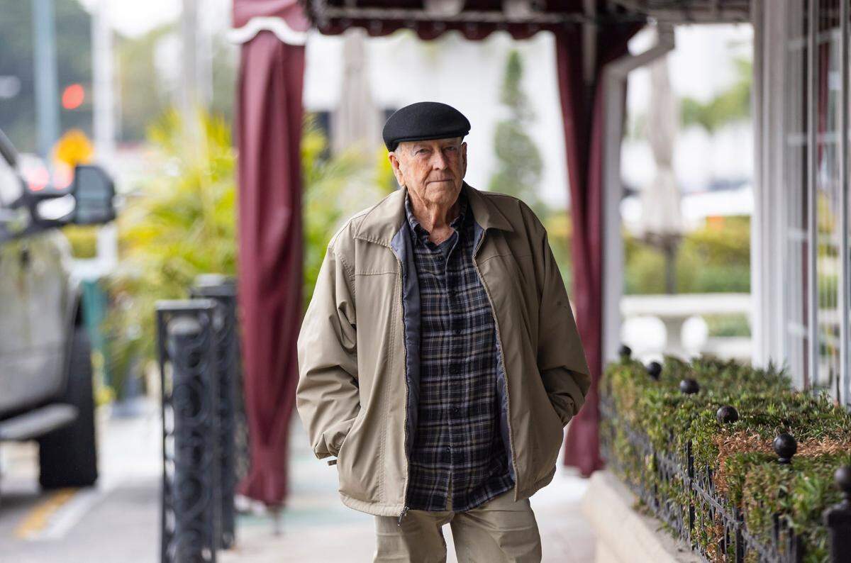Manuel Gomez, 81, arrives to Versailles Restaurant Cuban Cuisine as temperatures dip into the mid 40s across South Florida on Friday, Jan. 24, in Miami, Fla.