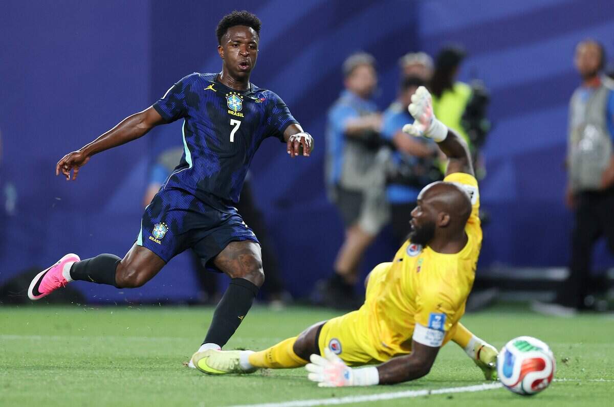 PHILADELPHIA, PENNSYLVANIA - JUNE 19:  Vinicius Junior #7 of Brazil scores his team's third goal against Johnny Placide #1 of Haiti during the FIFA World Cup 2026 Group C match between Brazil and Haiti at Philadelphia Stadium on June 19, 2026 in Philadelphia, Pennsylvania.  (Photo by Al Bello/Getty Images)