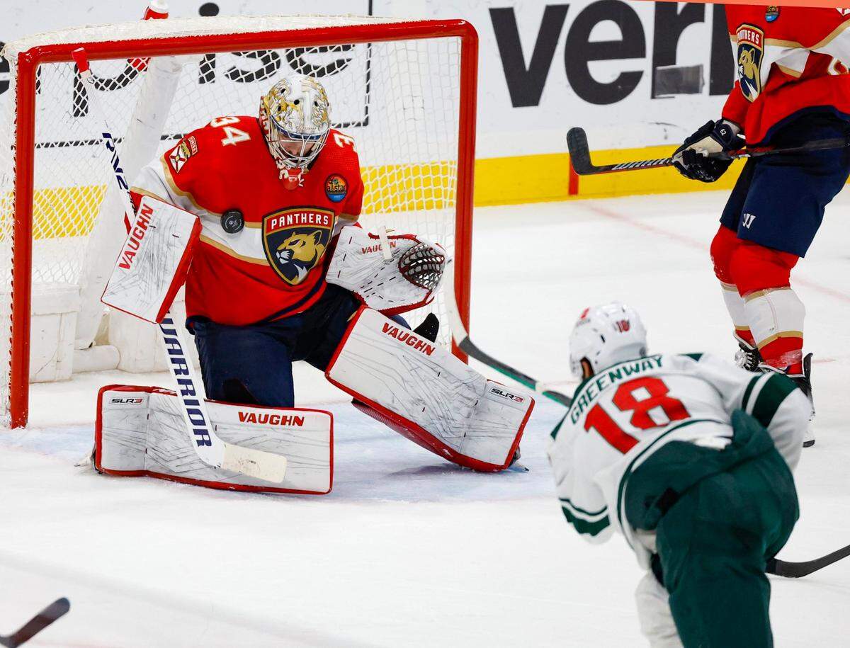 Florida Panthers goaltender Alex Lyon (34) blocks a shot at the goal by Minnesota Wild left wing Jordan Greenway (18) in the second period at FLA Live Arena in Sunrise, FL on Saturday, January 21, 2023.