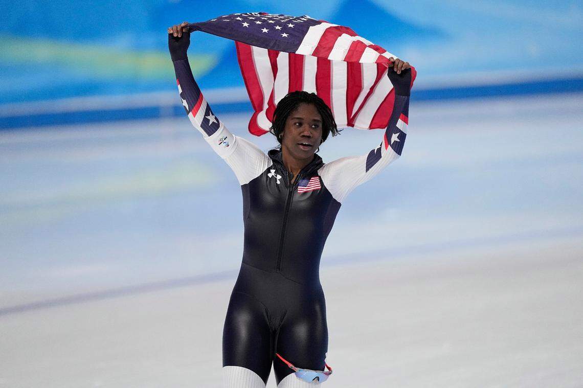 Erin Jackson of Ocala, Florida, skates on the ice hoisting an American flag after winning the gold medal in the speed skating women’s 500-meter race at the 2022 Winter Olympics, Sunday, Feb. 13, 2022, in Beijing.