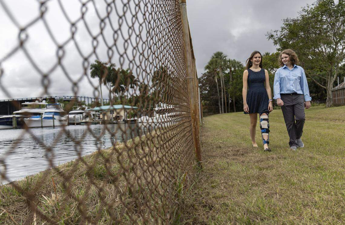 Students Eleonora Mariani, 13, left, and Nate Buck, 12, walk on the area where a potential new living shoreline may be built at New River Middle School on Thursday, Jan. 22, 2026, in Fort Lauderdale, Fla.