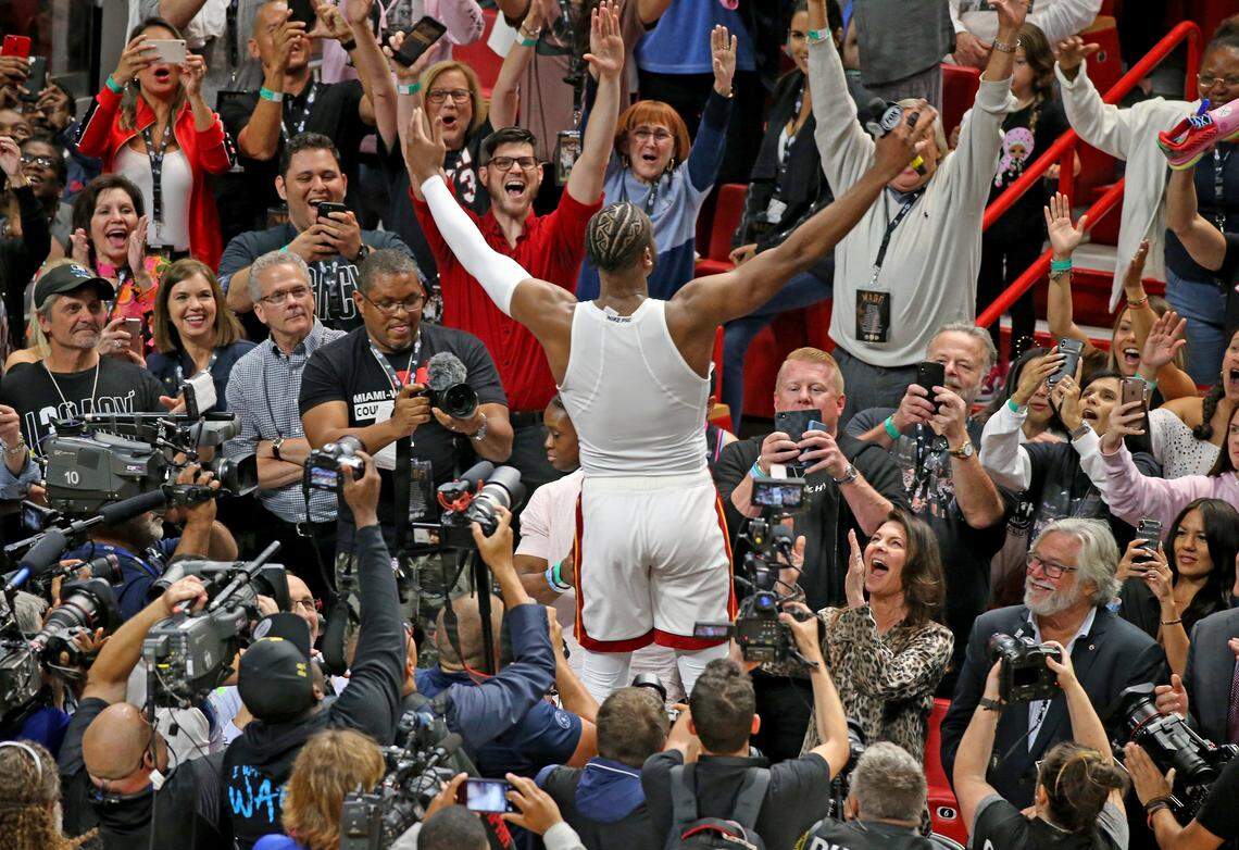 Dwyane Wade after his final game at the AAA jumps up on the scorer’s table to say goodbye to fans after the Miami Heat defeated the Philadelphia 76ers at AmericanAirlines Arena in Miami on April 9, 2019.