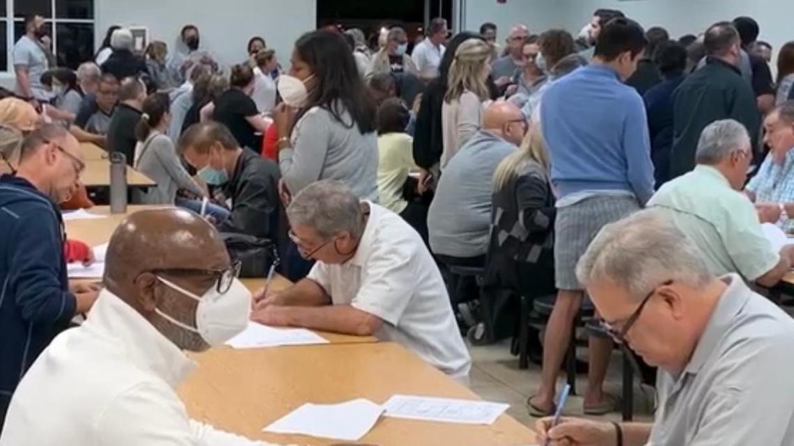 Hammocks residents at a Justice for the Hammocks meeting, signing petitions to recall the HOA board of directors.