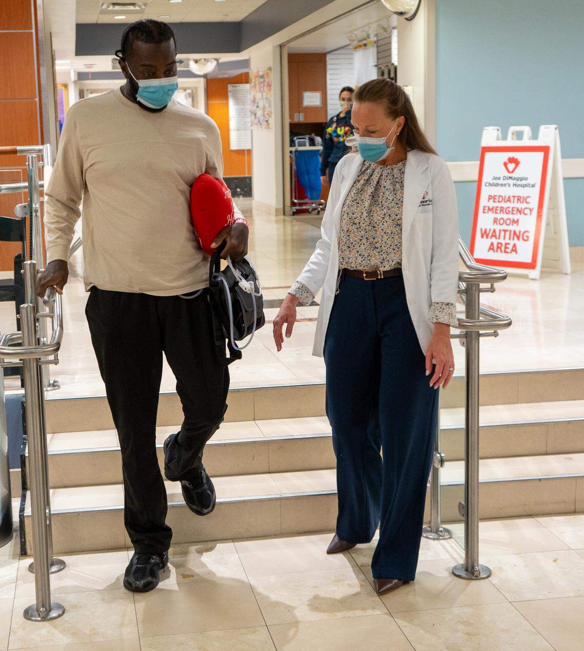 Chevon Byfield, 39, carefully walks down a set of stairs as he prepares to leave Memorial Regional Hospital in Hollywood with his new heart on Monday, March 30, 2026.