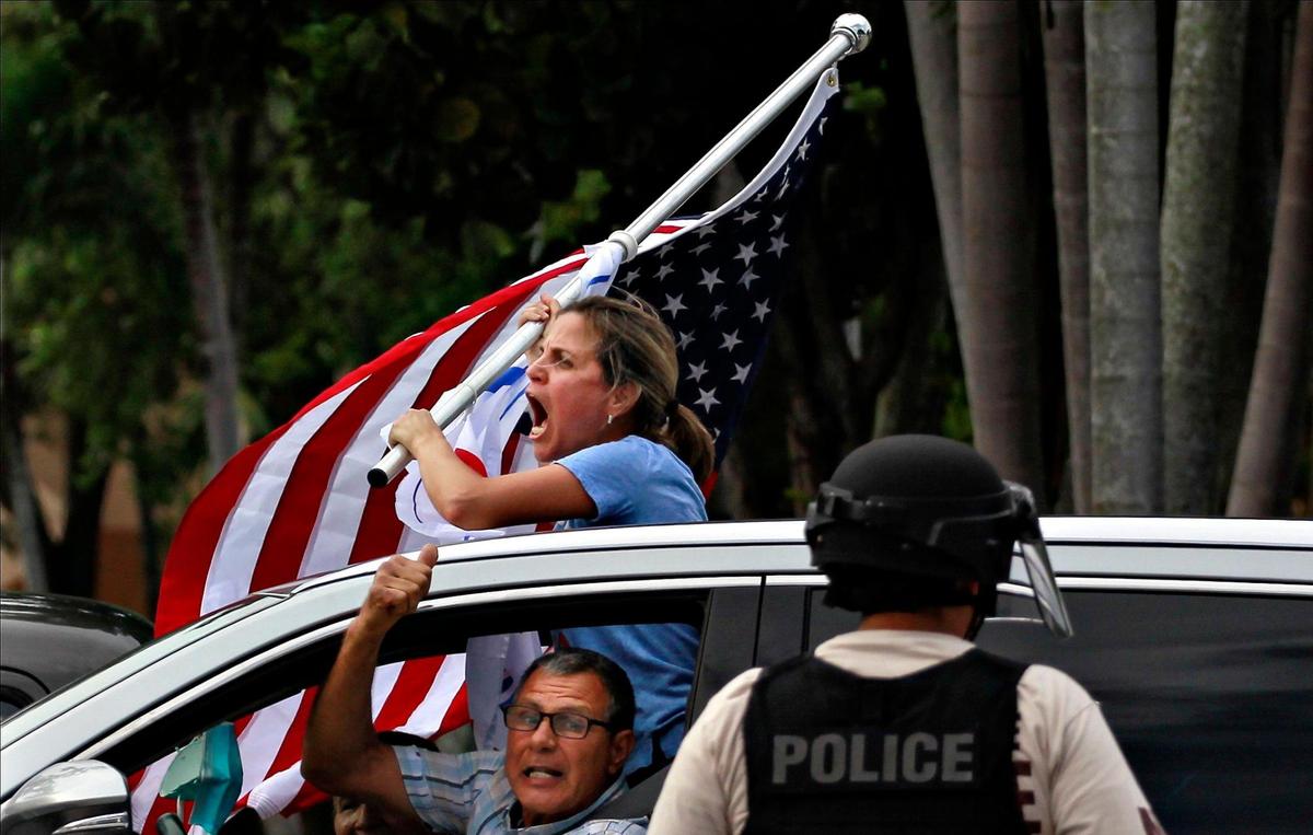 Pro-Trump supporters caravan westbound on NW 154th Street making their feelings known to Black Lives Matter demonstrators. Trump supporters and Black Live Matter protesters intersect at a distance as both groups engaged at 7900 block of NW 154th Street in Miami Lakes, Florida, on Sunday, June 28, 2020.