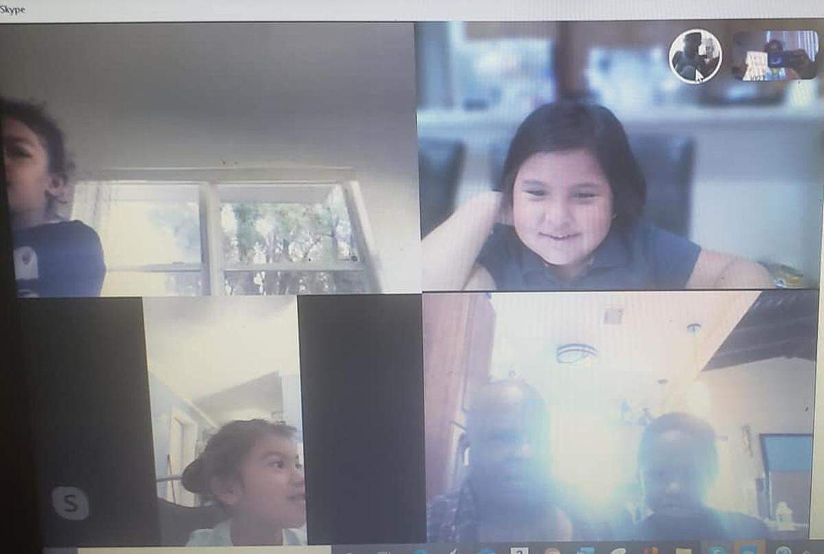 Students in Cassandra Holmes’ pre-K class at Eneida M. Hartner Elementary School in Miami listen as Holmes reads to them via Skype. Monday was the first day of distance learning in Miami-Dade County Public Schools.