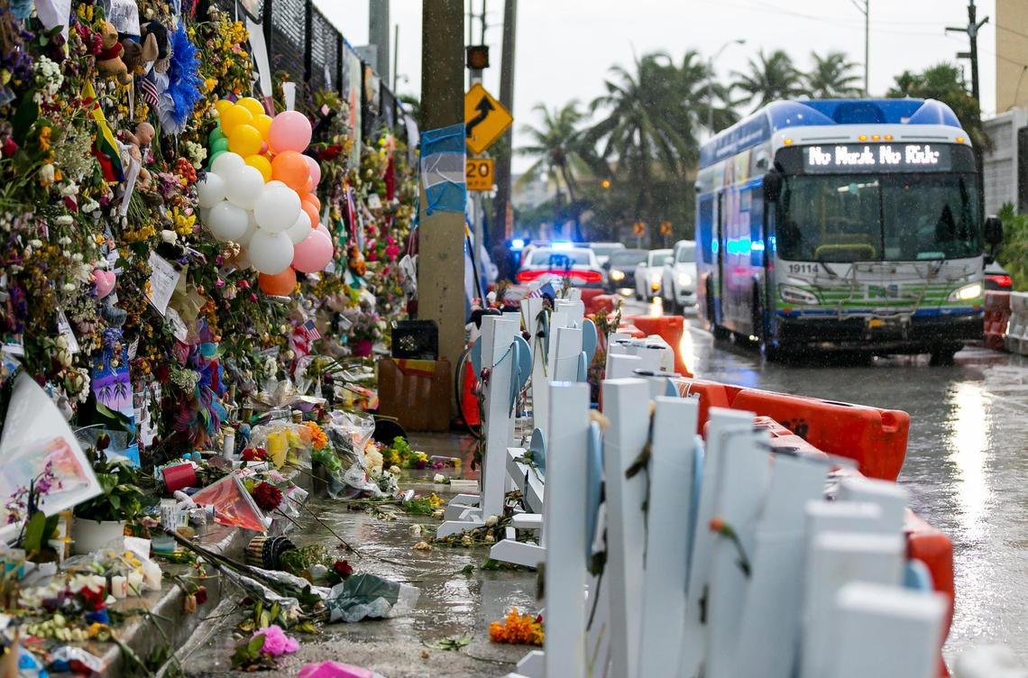 Rain falls on the Surfside Wall of Hope & Memorial as rescue teams continue their recovery mission at the collapsed Champlain Towers South building in Surfside on Monday, July 12, 2021.