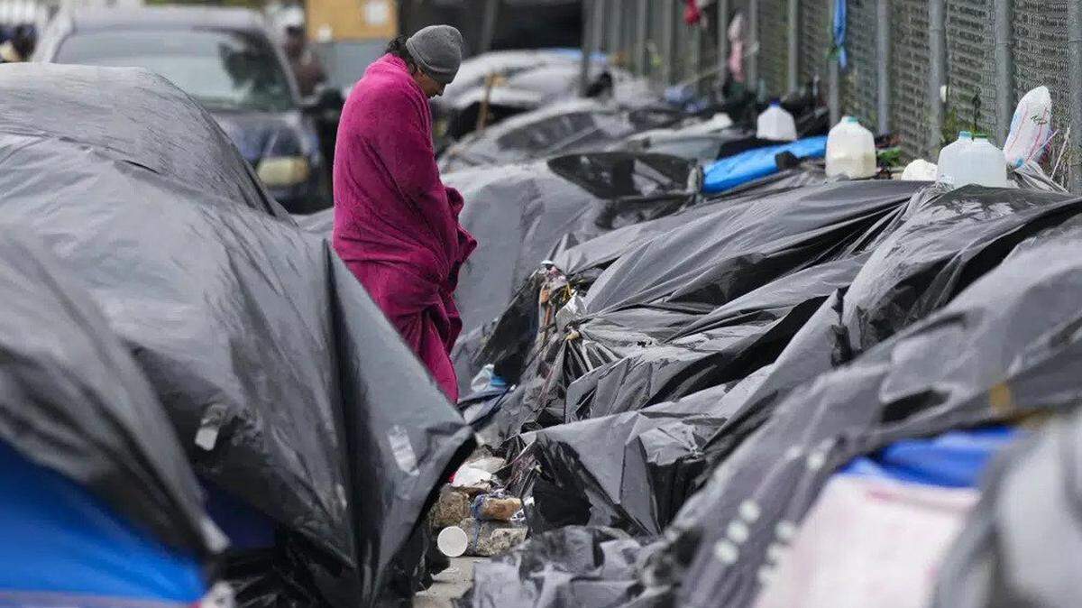 A migrant stands in cold weather at a makeshift camp on the U.S.-Mexico border in Matamoros, Mexico, in December.
