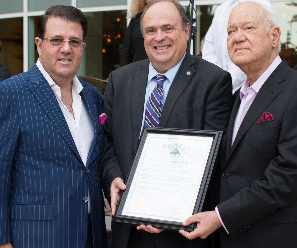 In celebration of Perry Ellis International's 50th anniversary and 20 years in Doral, the City of Doral's Mayor Juan Carlos Bermudez, center, presented Oscar Feldenkreis, left, and George Feldenkreis with a proclamation on Dec. 12, 2017, declaring it Perry Ellis International Day 2017.