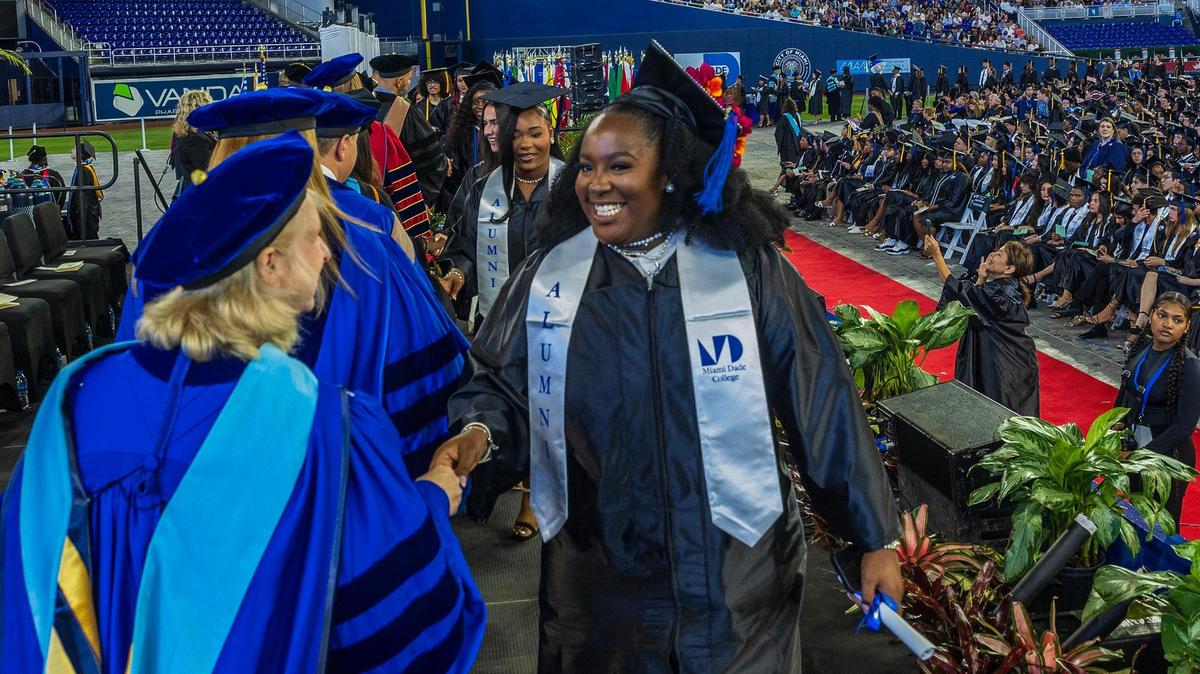 Faculty members hand diplomas to graduating students during Miami Dade College’s North, Hialeah and West Campuses 2025 commencement ceremonies at LoanDepot Park, in Miami on Saturday, April 26, 2025.