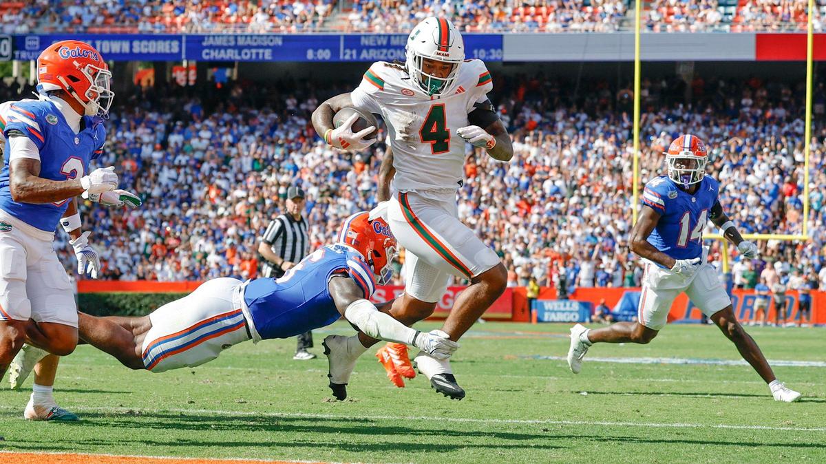 Miami Hurricanes running back Mark Fletcher Jr. (4) breaks a tackle by Florida Gators linebacker Shemar James (6) for a touchdown in the second quarter at Ben Hill Griffin Stadium in Gainesville, Florida, on Saturday, August 31, 2024.