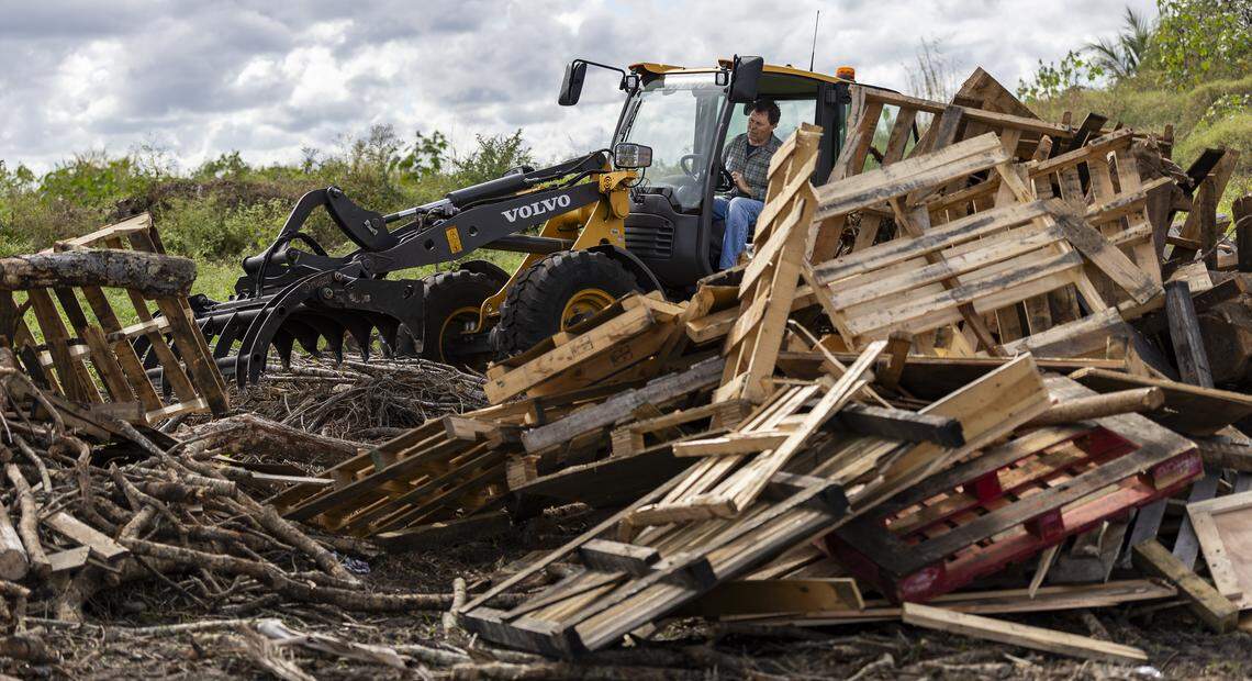 Burke Powers, an engineering manager with Air Burners, uses an electric compact wheel loader to shift wood waste on Thursday, Jan. 8, 2026, in Palm City, Fla. Air Burners is a manufacturer of air curtain burner systems, which provide a controlled way to dispose of wood and other vegetative waste.