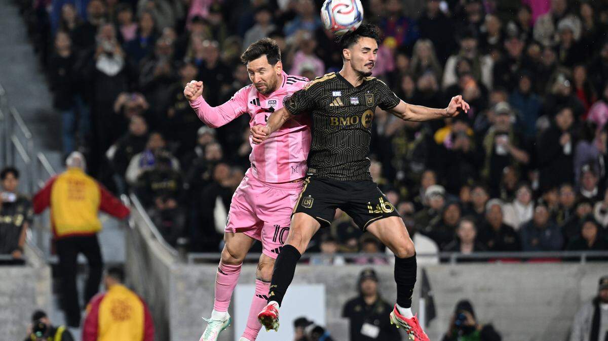 LOS ANGELES, CALIFORNIA - FEBRUARY 21: Lionel Messi #10 of Inter Miami CF and Stephen Eustaquio #46 of Los Angeles FC jump for the ball during the MLS match between Los Angeles Football Club and Inter Miami CF at Los Angeles Memorial Coliseum on February 21, 2026 in Los Angeles, California. (Photo by Shaun Clark/Getty Images)