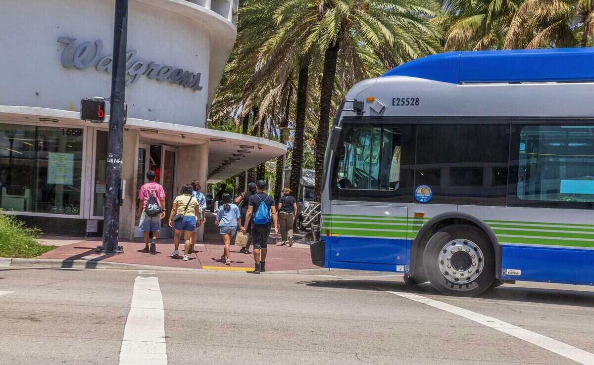 A bus passes as pedestrians crosses the street intersection at Lincoln Road and Collins Avenue, a hotspot where pedestrians get hit and seriously injured or killed, on Thursday June 11, 2026.